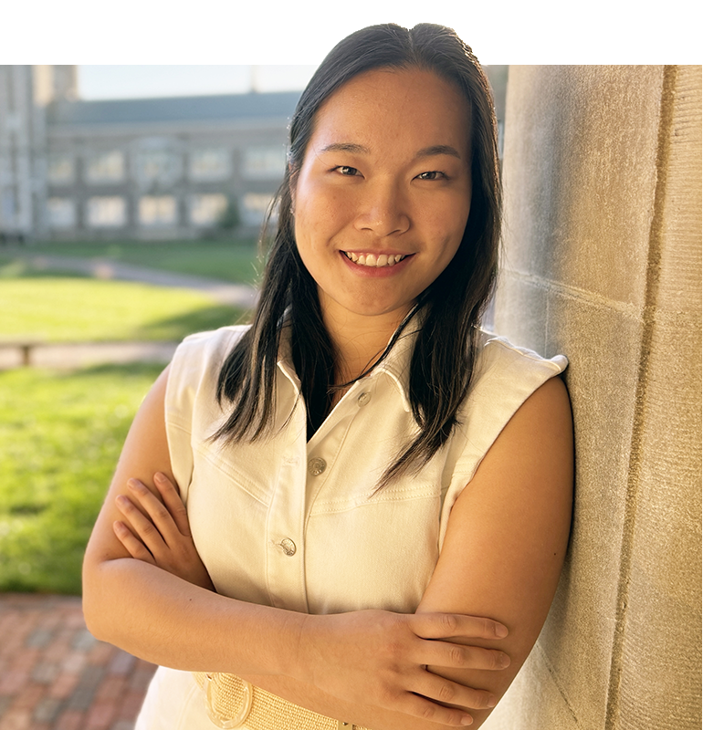 Tiffany Zhu standing along a column