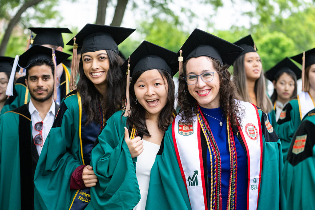 three women smile during commencement