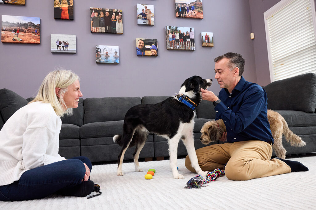 Scott with his wife playing with their dog