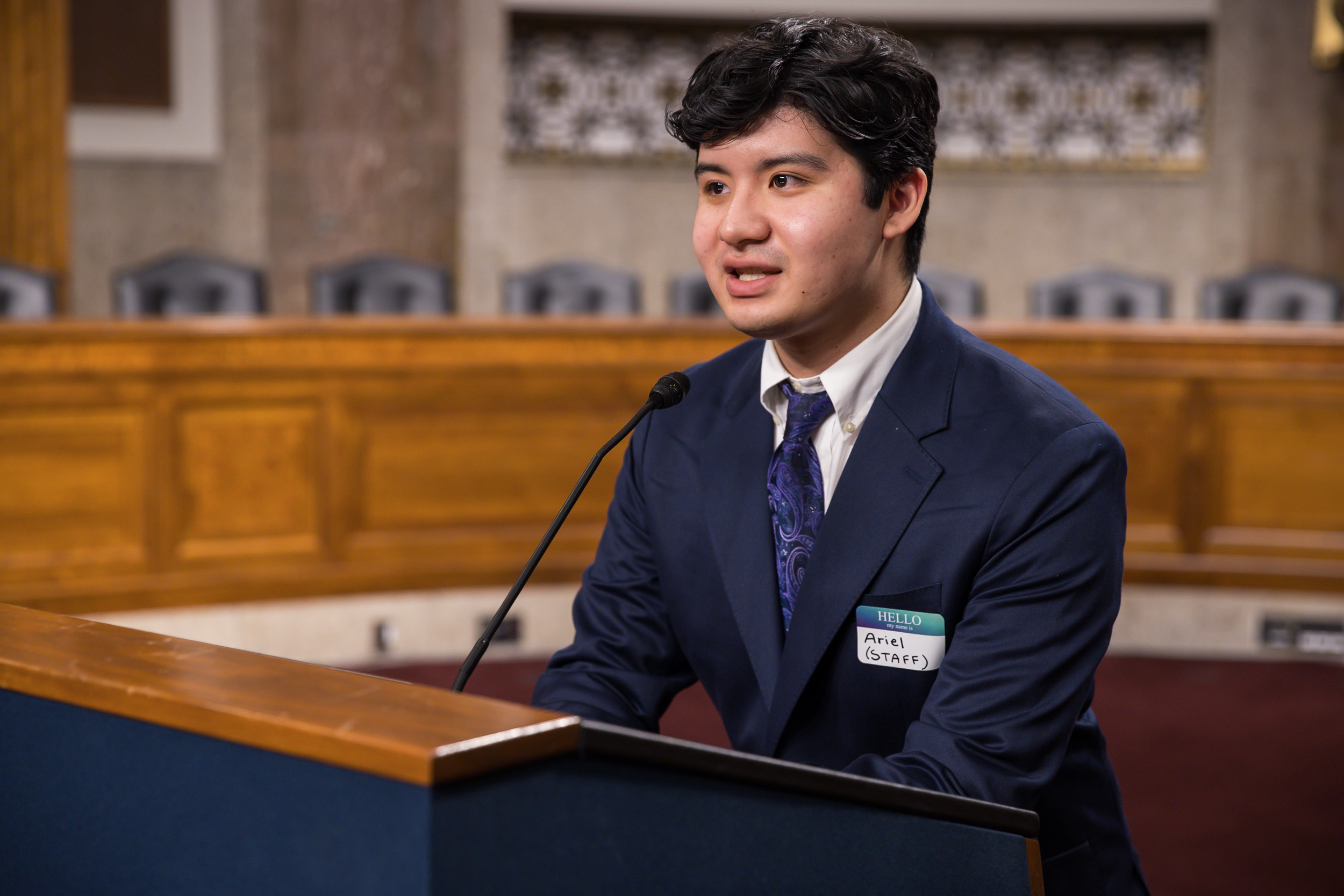 Ariel Nochez speaking at the lectern