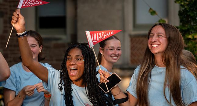 students waving pennants at convocation